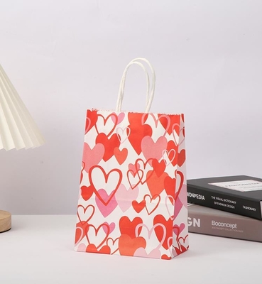Un buon prezzo. Il regalo rosso di carta kraft di 80gsm insacca la carta stampata cuore Goodie di amore insacca con le maniglie in linea